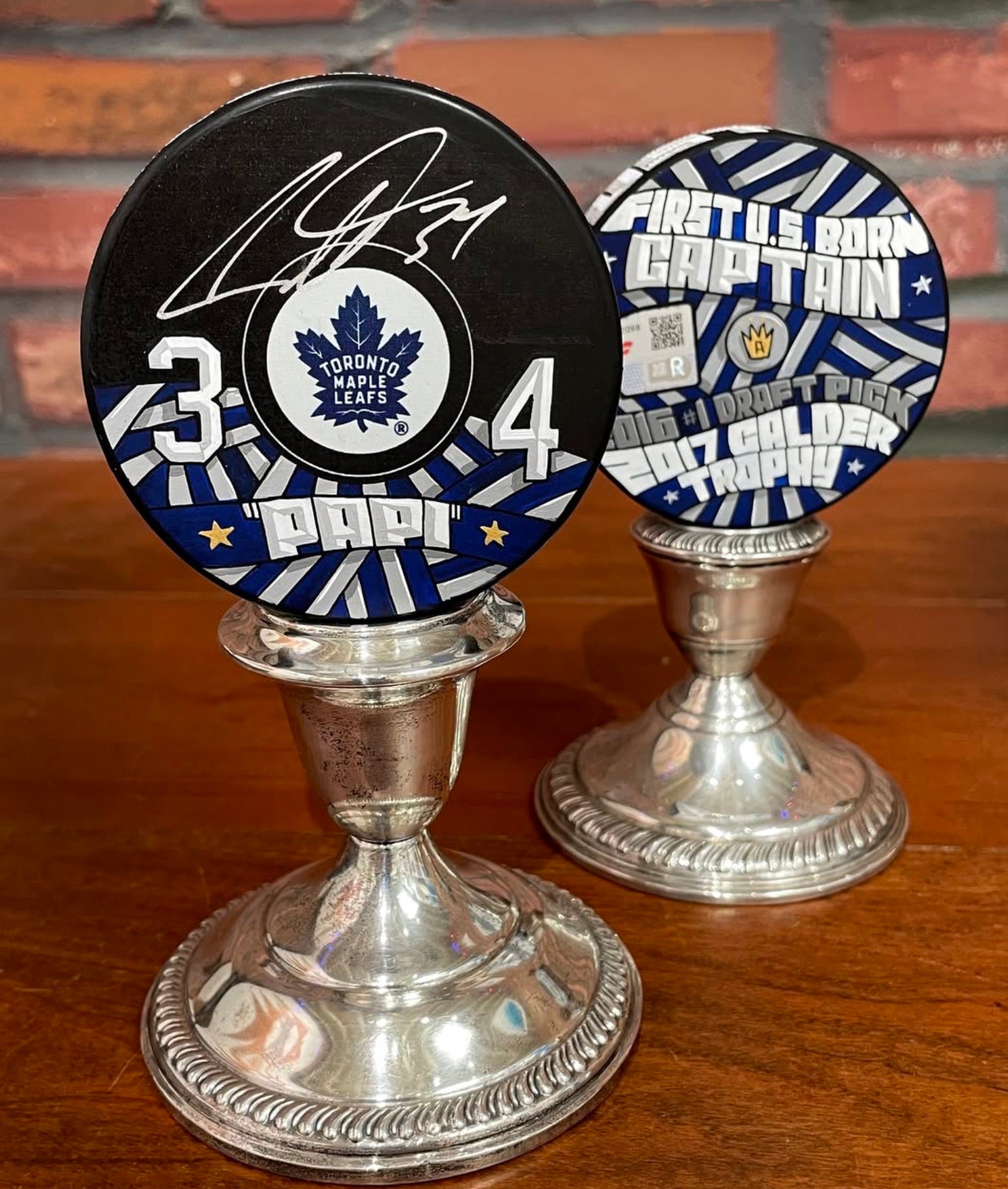 Custom Toronto hockey pucks painted by Mike Floyd