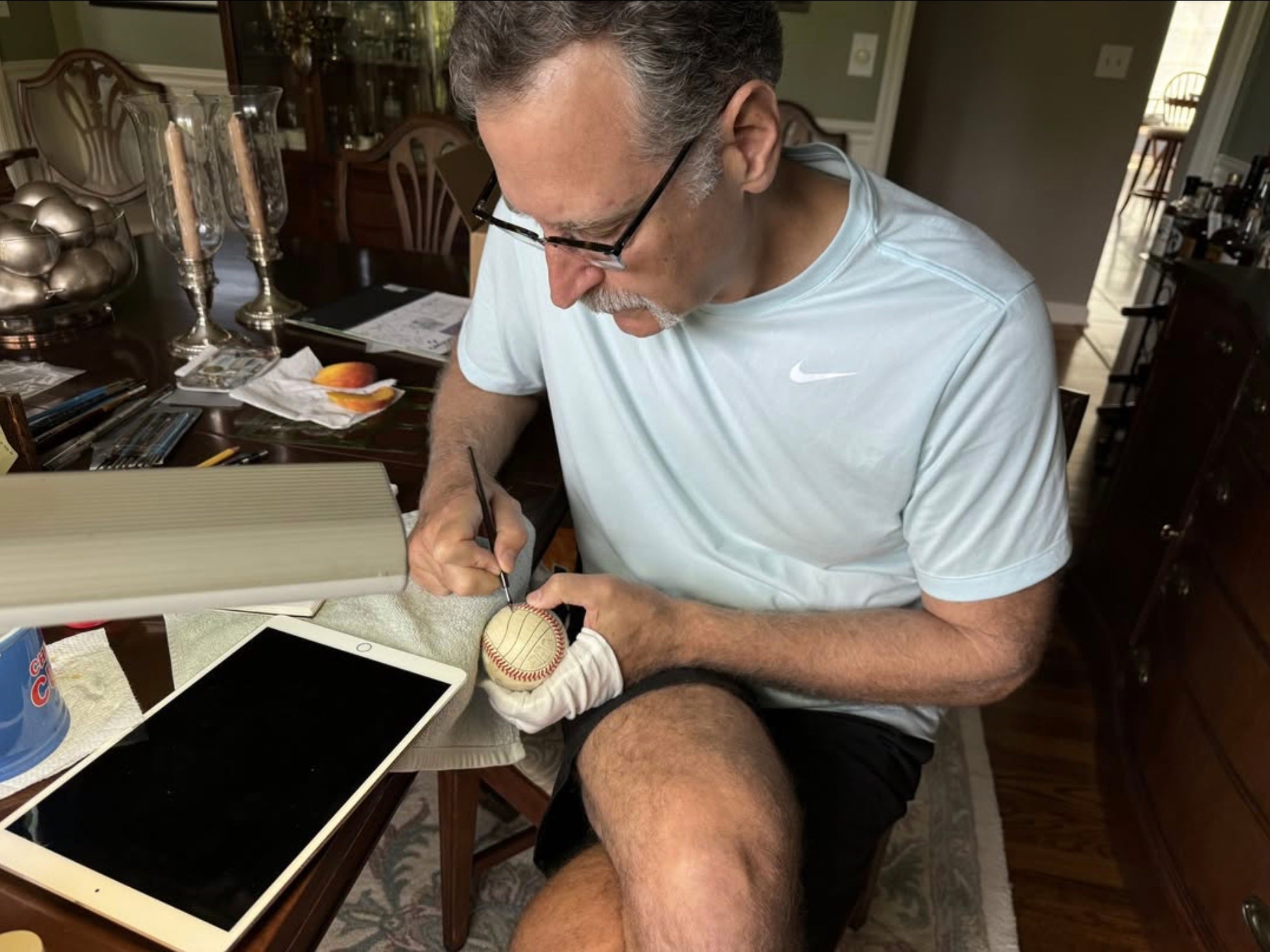 Mike Floyd hand-painting a baseball