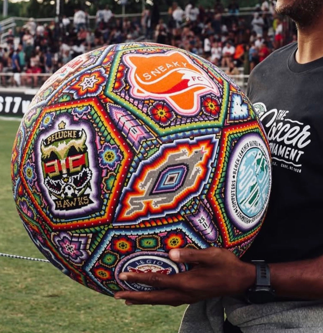 Close view of a Soul Made Arte beaded soccer ball with club-inspired panels